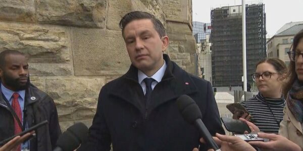 Pierre Poilievre attends Speech From The Throne with face pressed against Senate window